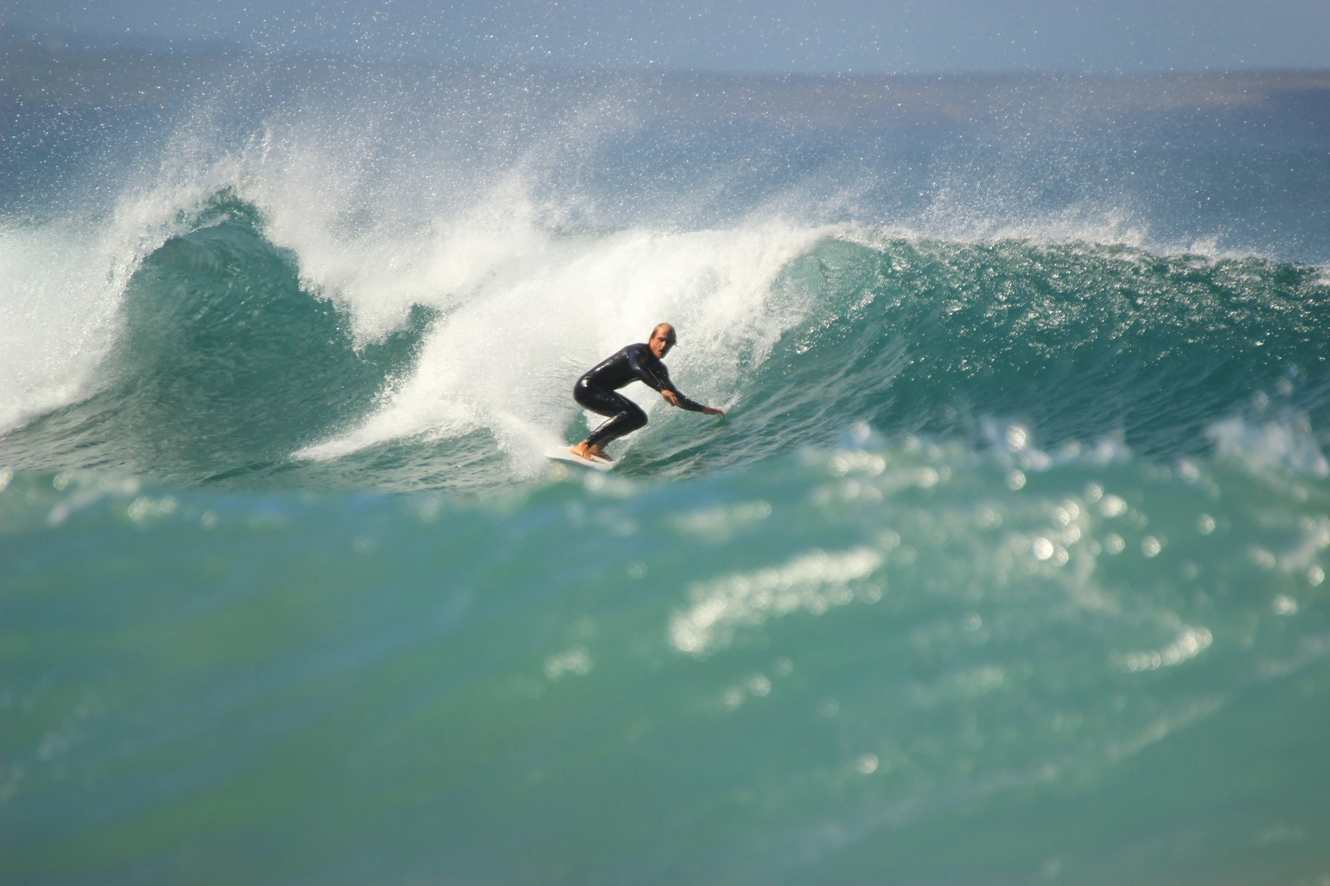 Jon Barra surf photography of a surfer riding a glassy Atlantic wave in Portugal